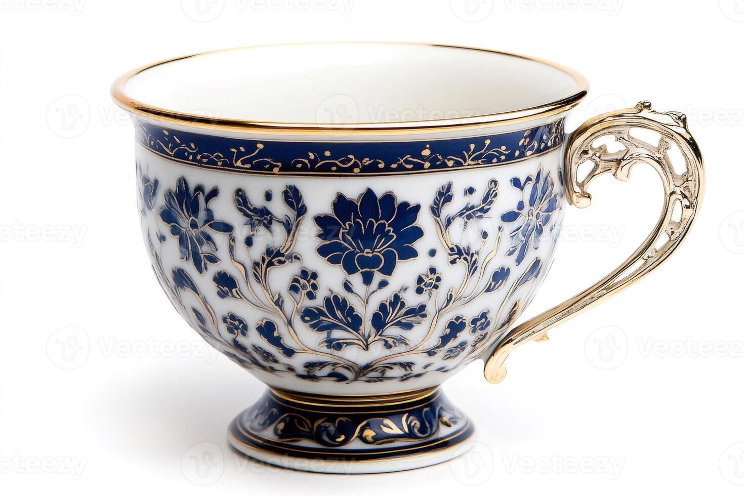 Antique porcelain teacup with gold decorations and blue floral patterns standing on white background photo