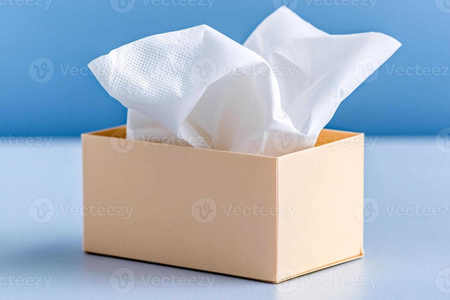 White tissues emerging from beige dispenser on blue background photo