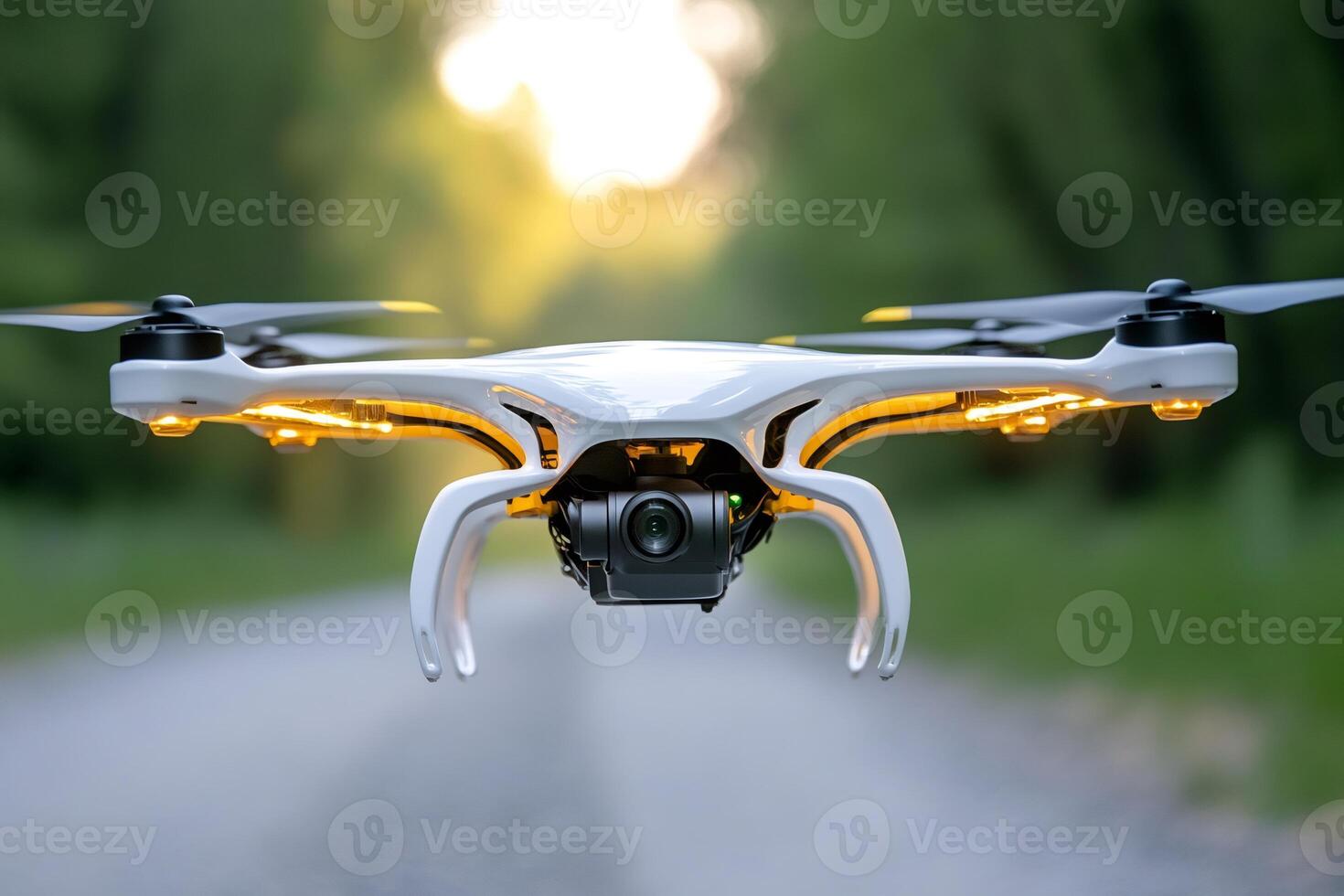 White professional drone hovering with camera and led lights at sunset photo