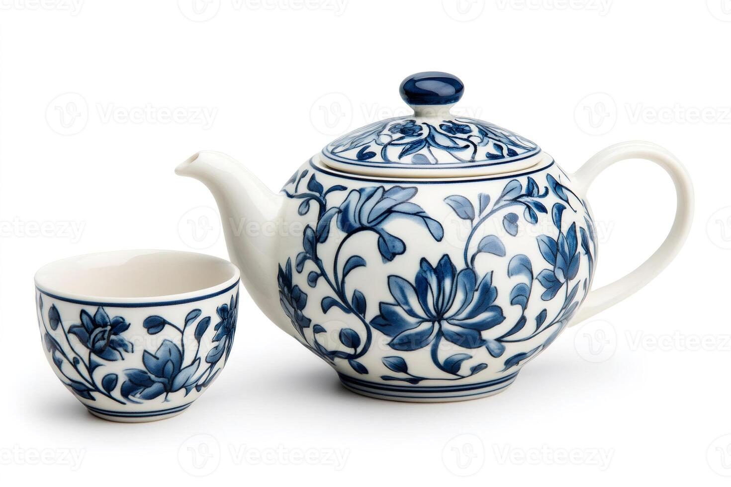 Blue and white porcelain teapot and teacup with floral design photo