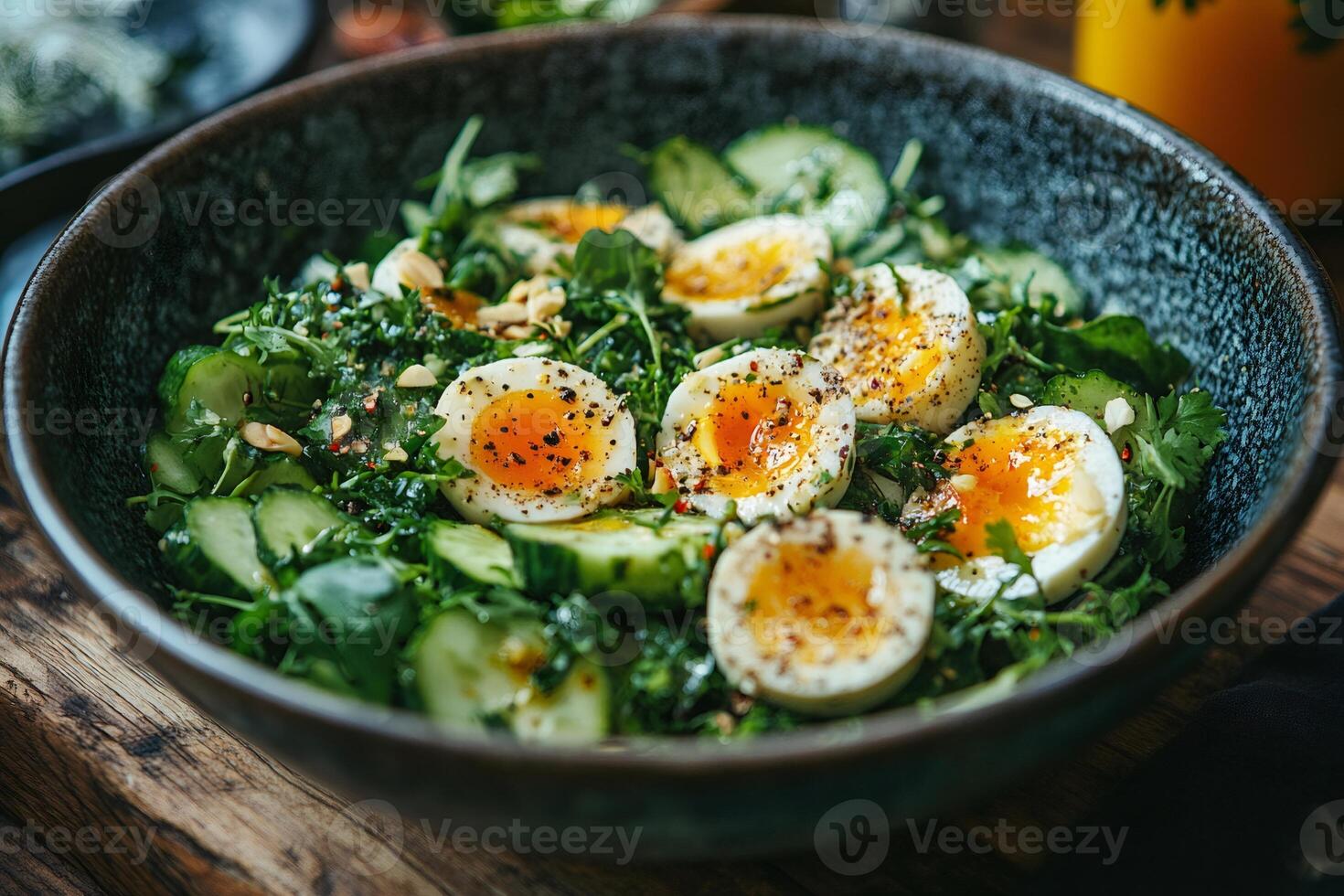 Healthy green salad with boiled eggs, cucumber, arugula, parsley and spices in a bowl photo