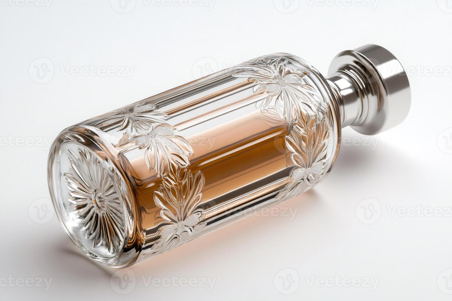 Elegant crystal perfume bottle lying on white surface with flower decoration photo