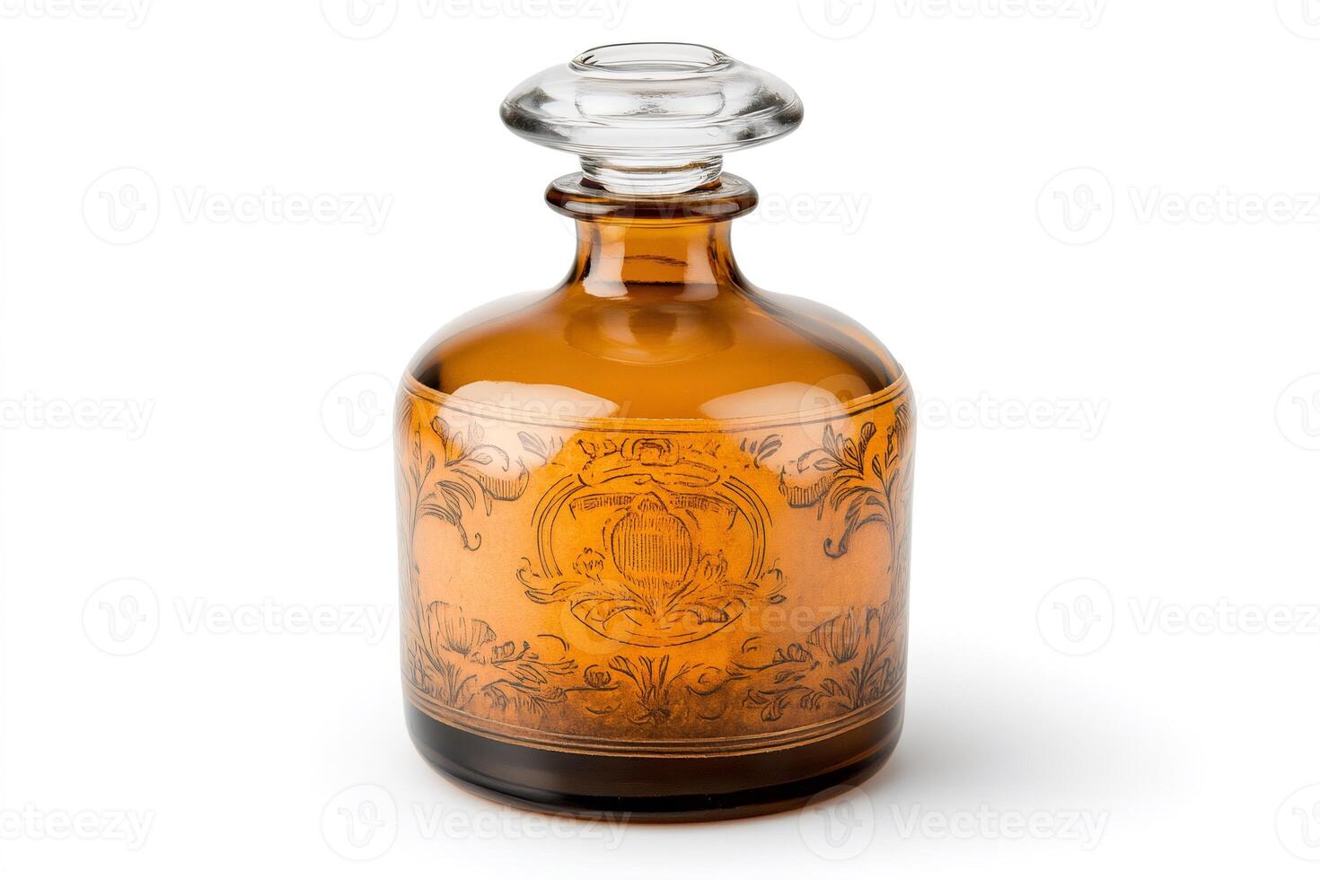 Studio shot of vintage amber decanter with etched floral decoration and glass stopper photo