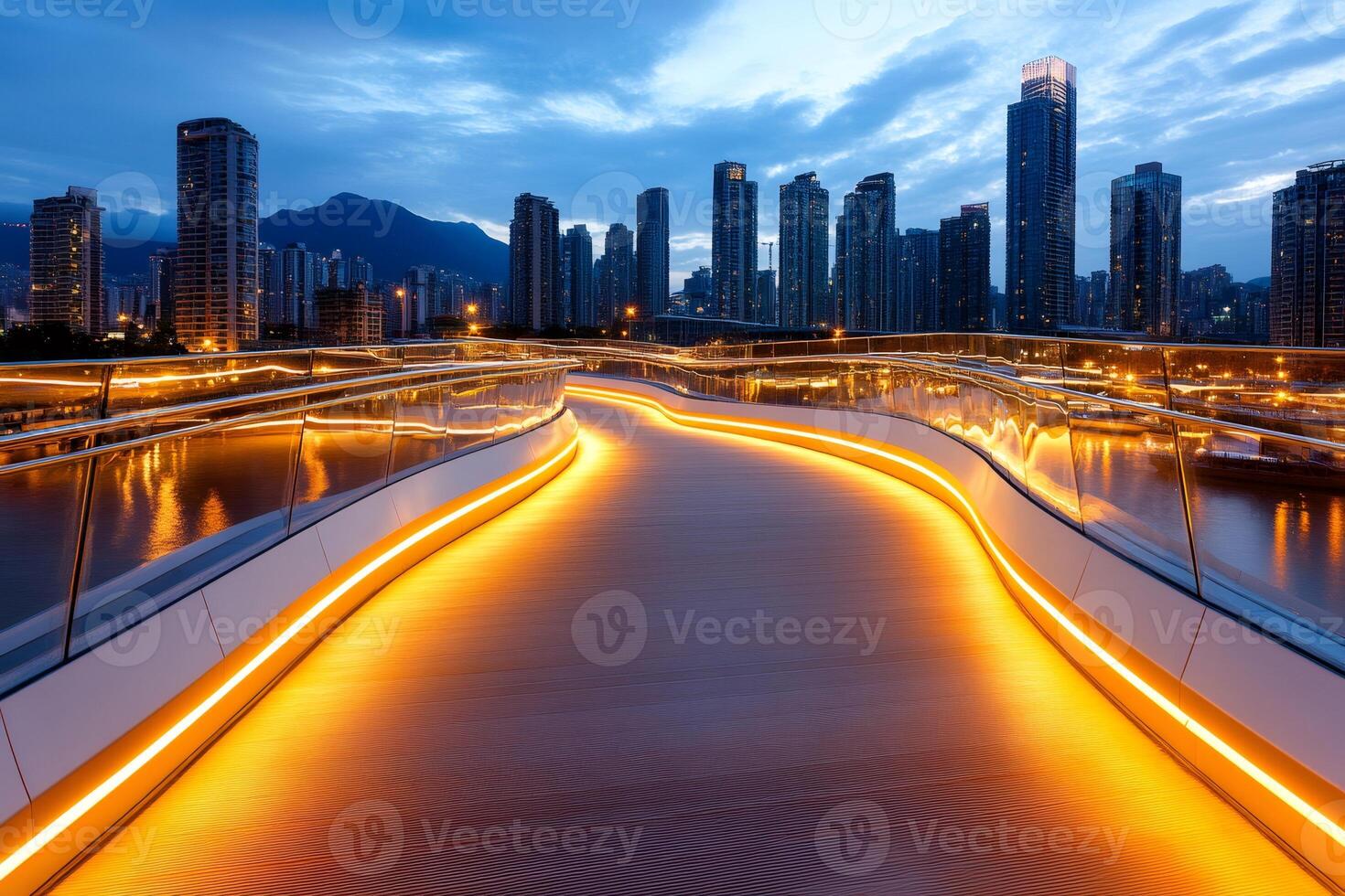 Illuminated pedestrian bridge crossing river in modern city at dusk photo