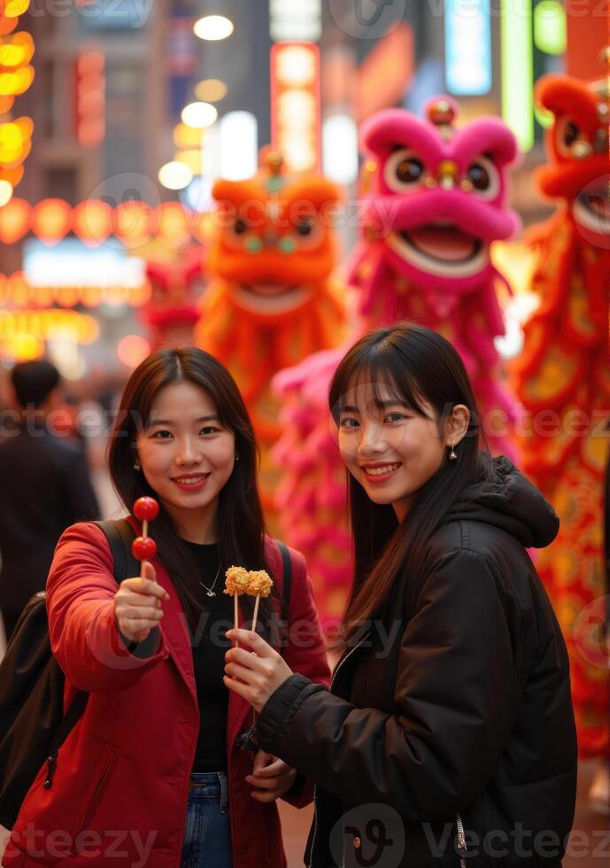 Two women holding chopsticks photo