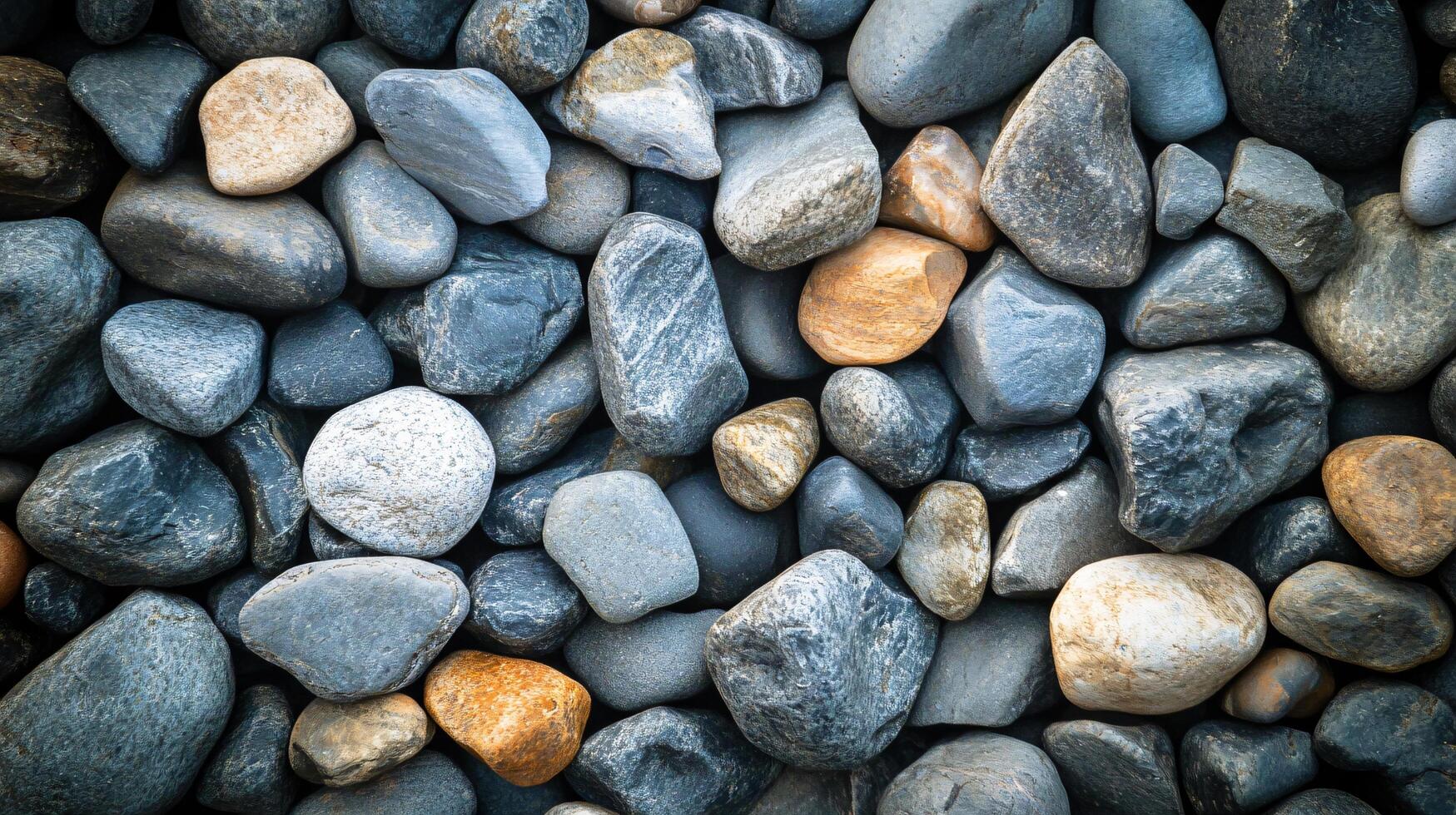 A pile of rocks with some of them being gray and some of them being brown photo