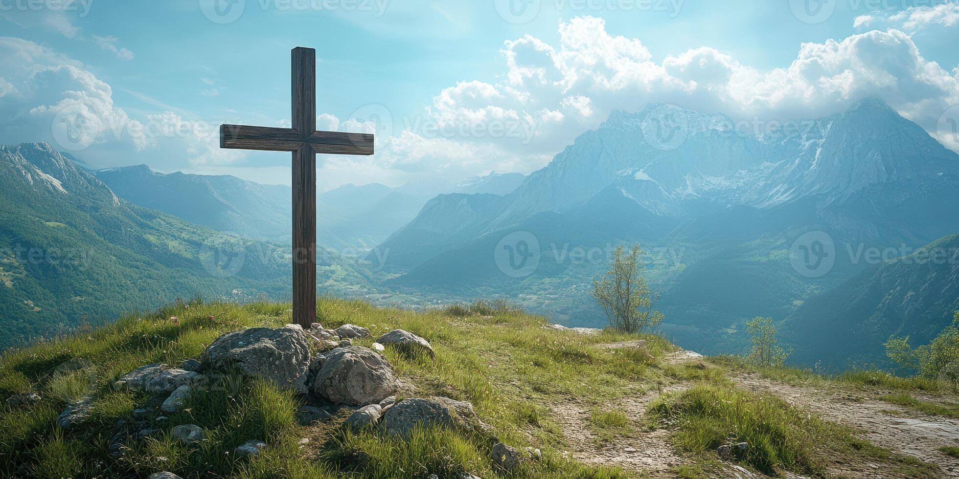 Wooden cross on a hilltop overlooking a majestic mountain landscape under a vibrant sky at twilight photo