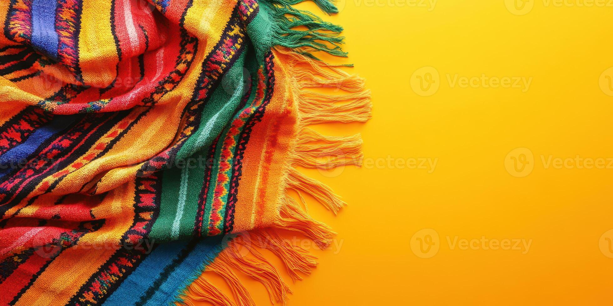 Colorful woven blanket draped on vibrant yellow background showcasing intricate patterns and textures photo