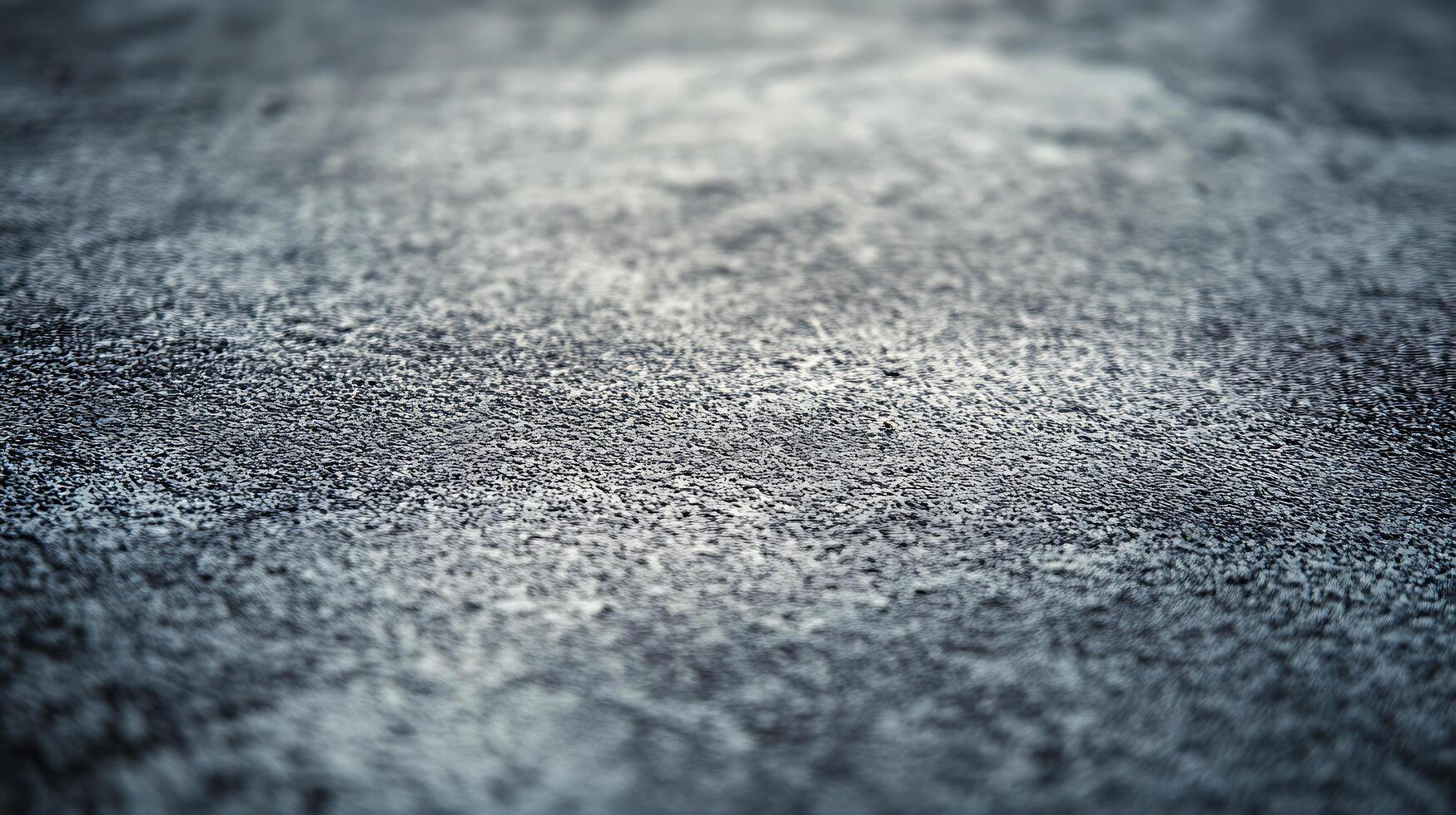 A blurry image of a grey surface with a few white specks photo