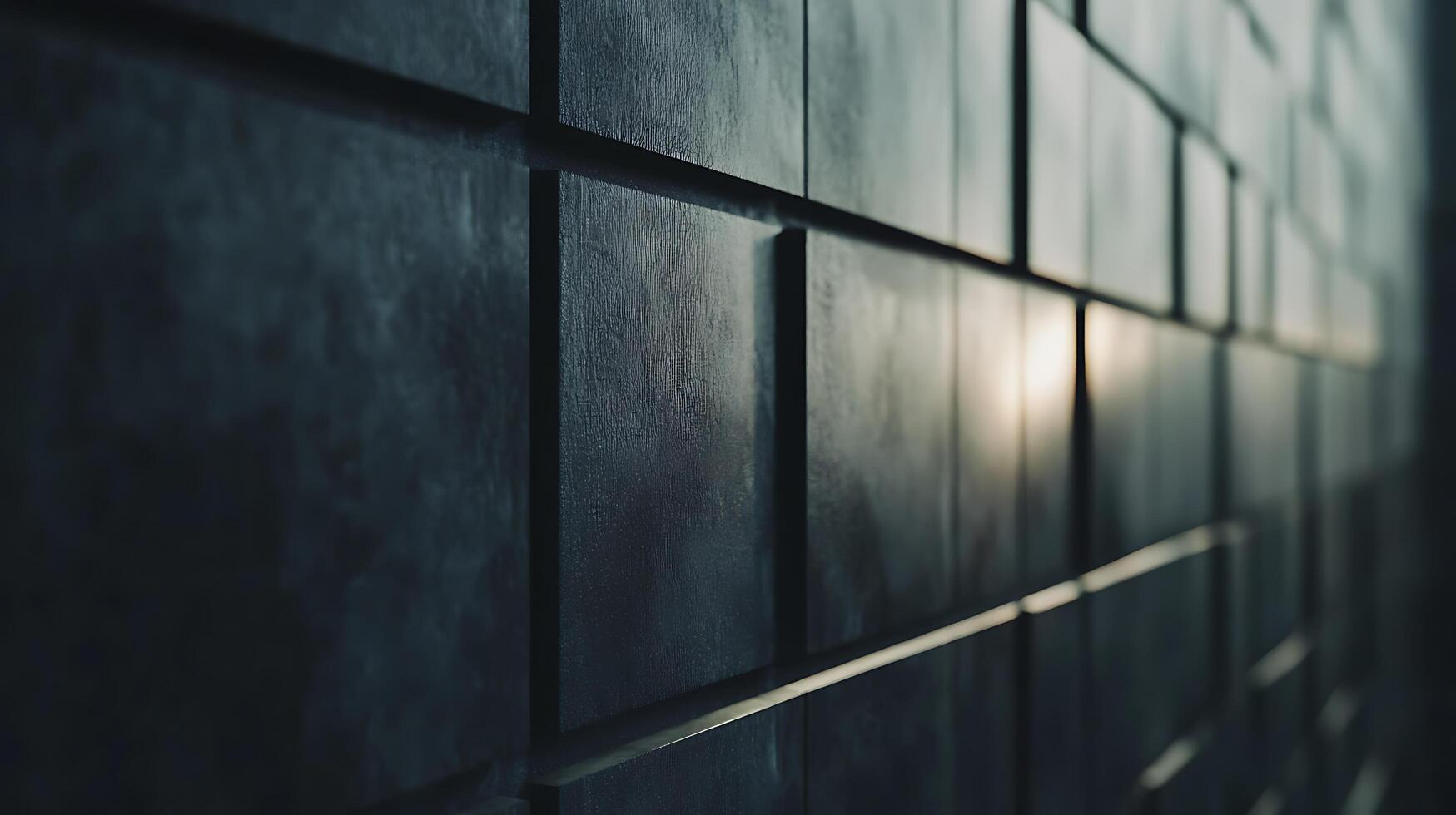 A wall made of black tiles with a sun shining on it photo