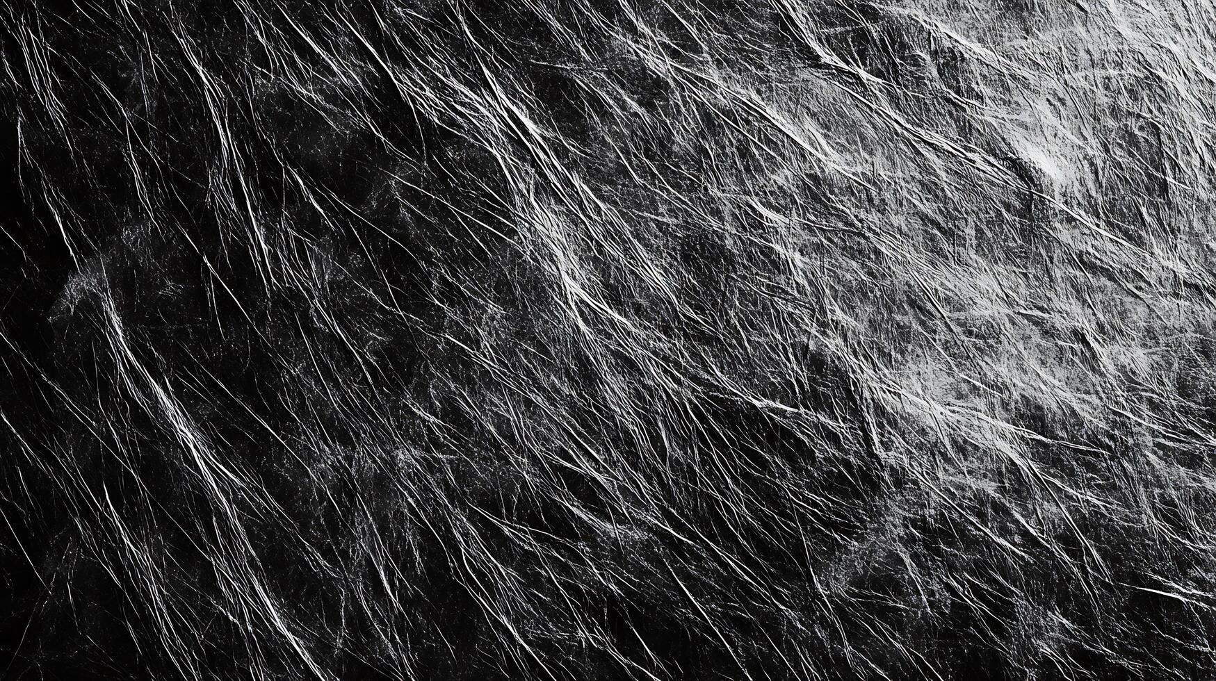 An abstract black and white image featuring an irregular shiny textured surface with many fine white lines or streaks across a dark background photo