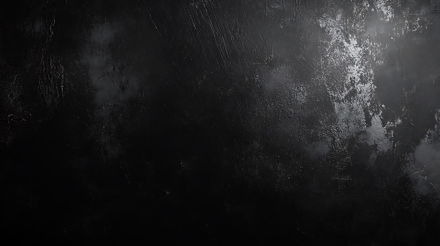A textured dark surface with subtle gradients of black and gray reminiscent of a weathered material under dim lighting photo
