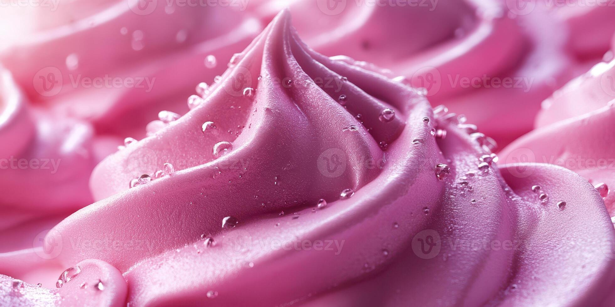 Delicious pink frosting on a cake with delicate swirls and moisture droplets captured in soft light photo