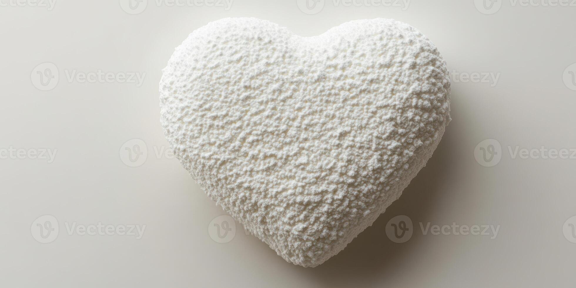 White heart-shaped object resting on a plain surface showcasing texture and shape photo