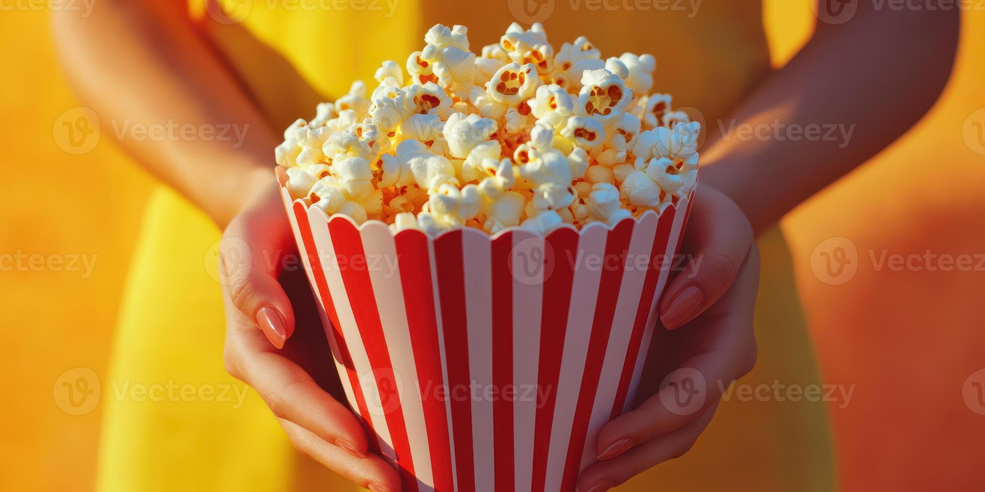 Enjoying fresh popcorn in a cheerful outdoor setting during a sunny day photo