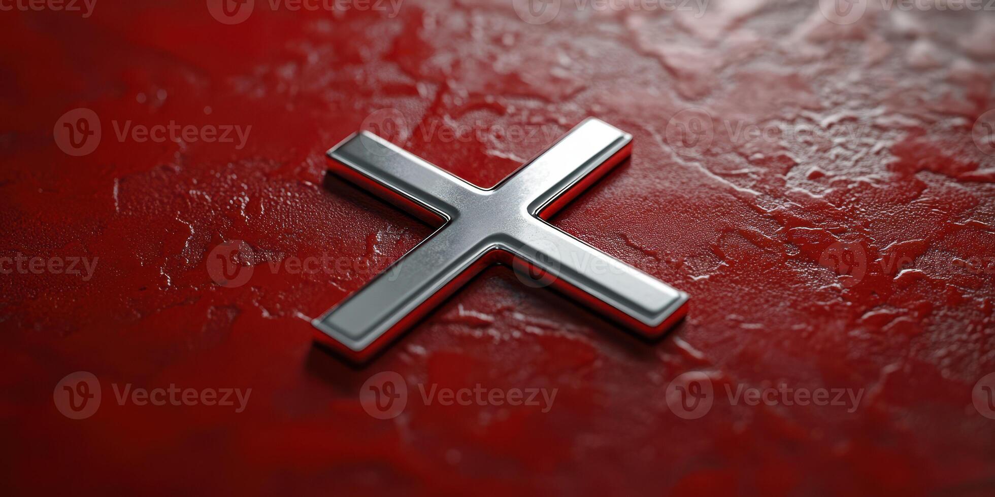 Metal cross design on a textured red surface showcasing modern artistic elements and contrasting colors photo