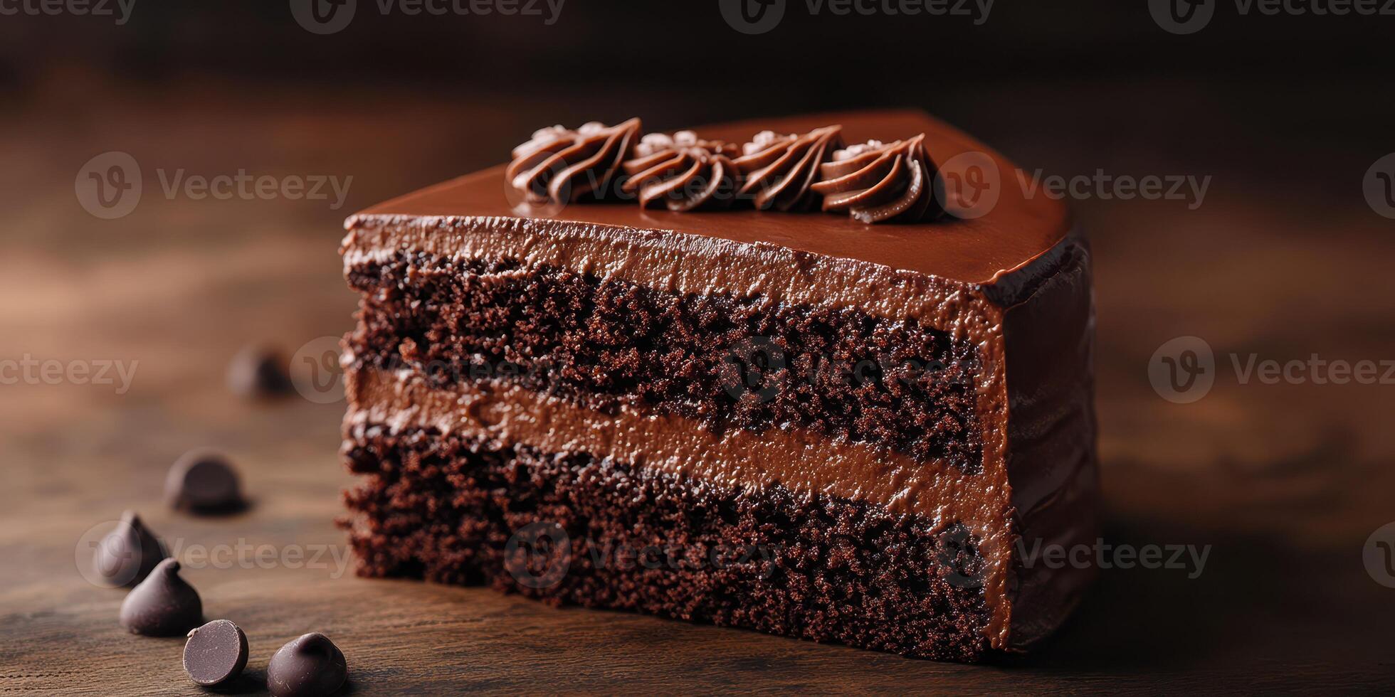 Chocolate cake slice with rich frosting and chocolate chips on wooden table background photo