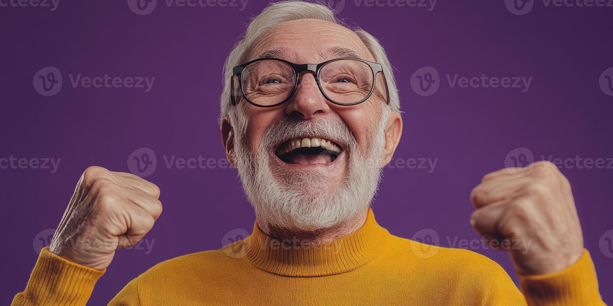 Happy elderly man celebrating with joy in a vibrant studio background during a cheerful moment photo