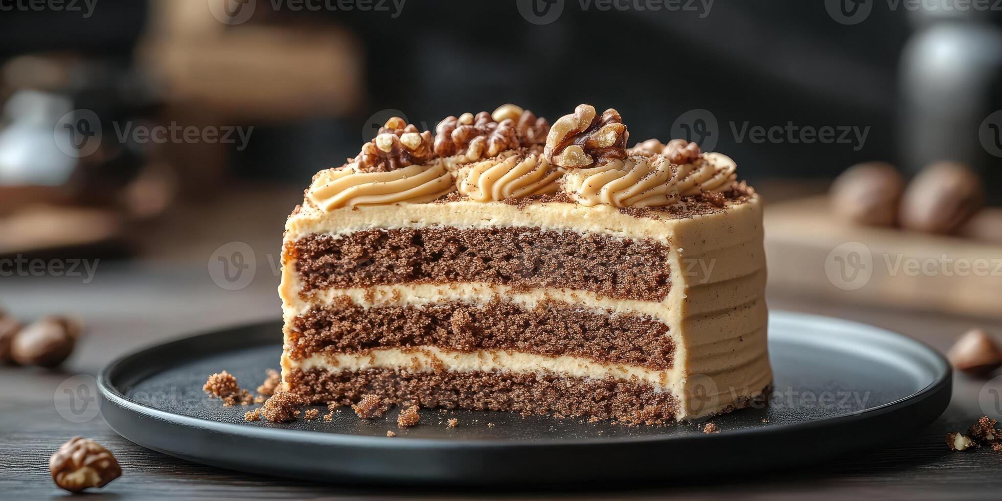 Delicious chocolate cake slice served on a black plate with walnuts on top and rich frosting photo