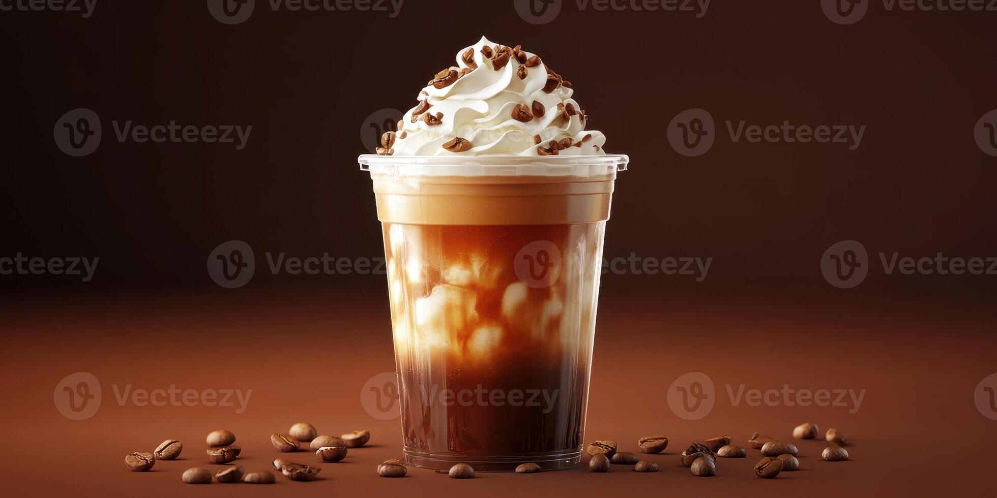 Creamy coffee drink topped with whipped cream and coffee beans in a clear cup on a brown background photo