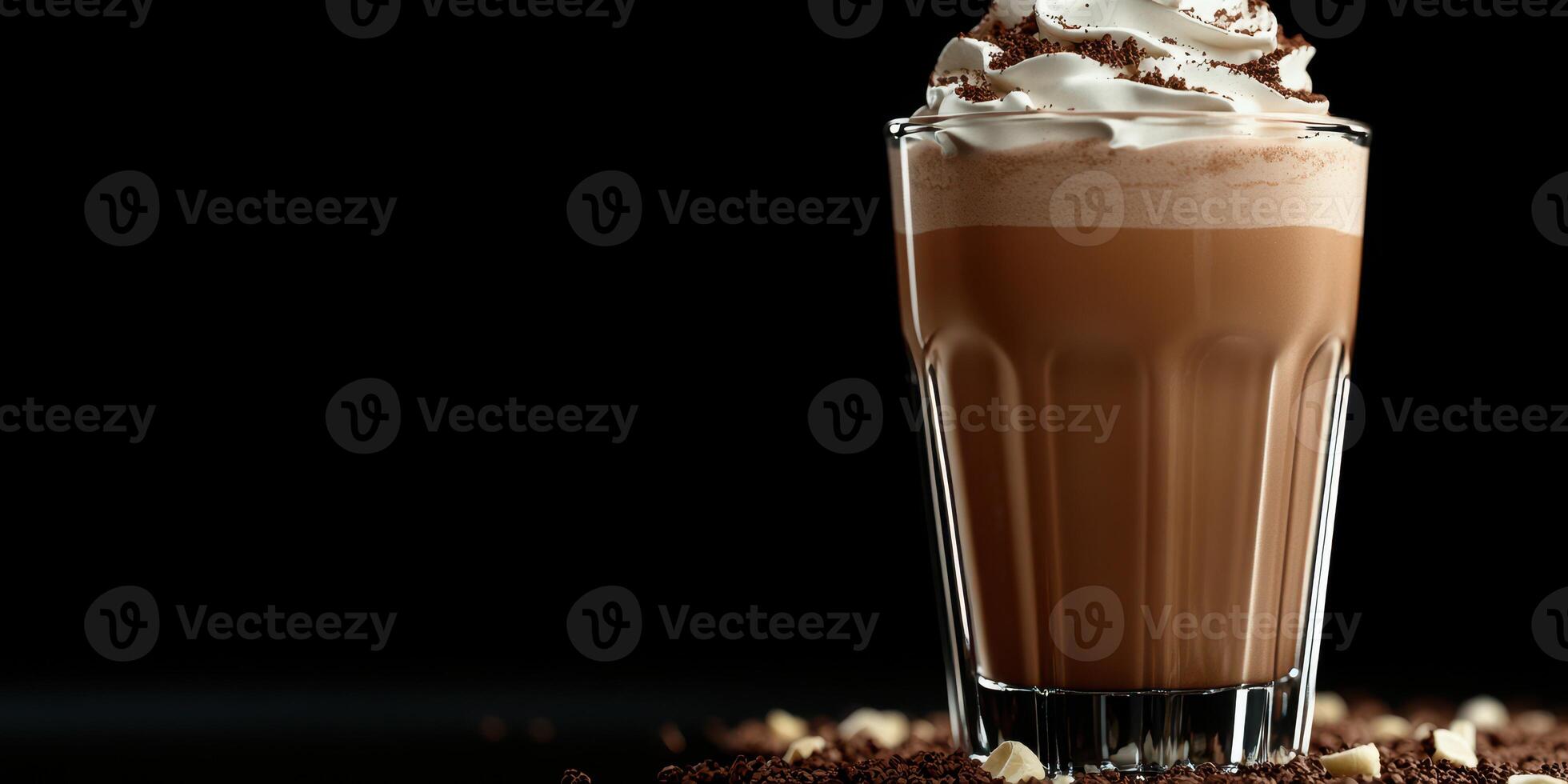 Rich chocolate drink topped with whipped cream served in a glass against a dark background photo