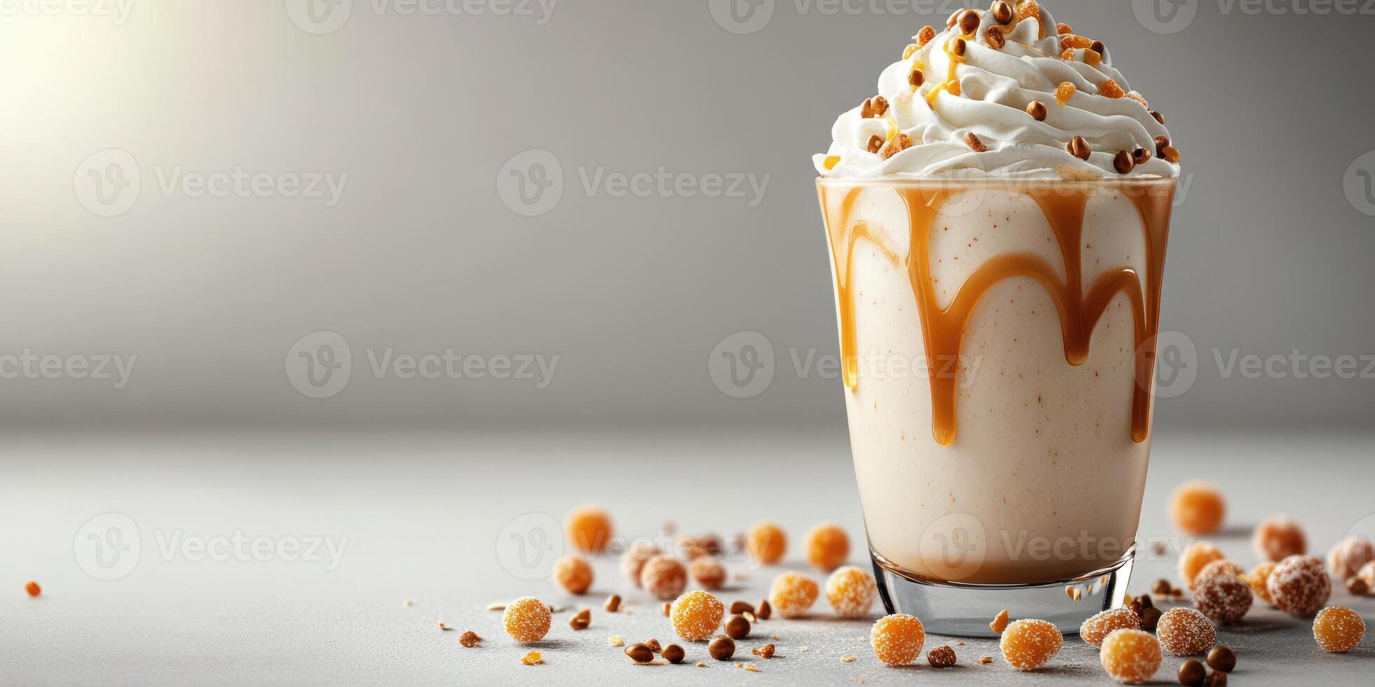 Creamy vanilla dessert topped with whipped cream and caramel sauce on a light gray surface photo