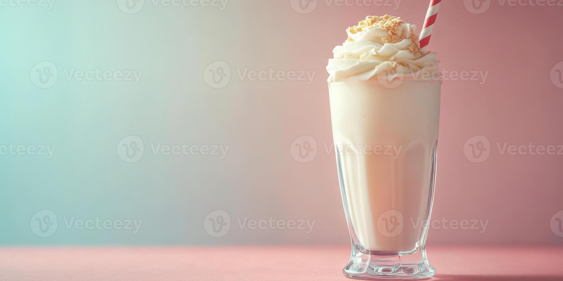 Creamy milkshake topped with whipped cream and a red straw served in a tall glass against a pastel background photo