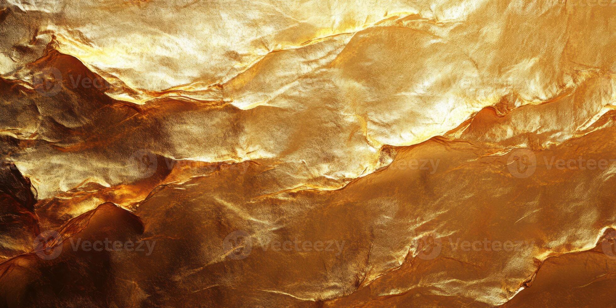 Textured golden surface with ripples showing shine and depth in warm light photo