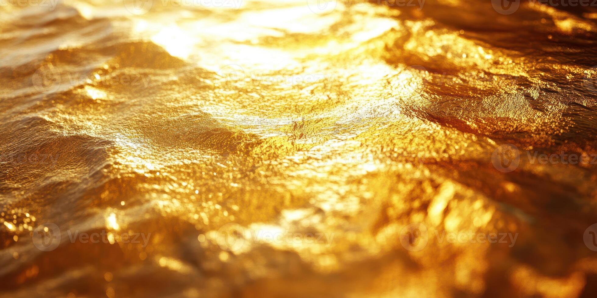 Golden waves shimmer under the sunlight by the ocean during sunset in a tranquil coastal setting photo