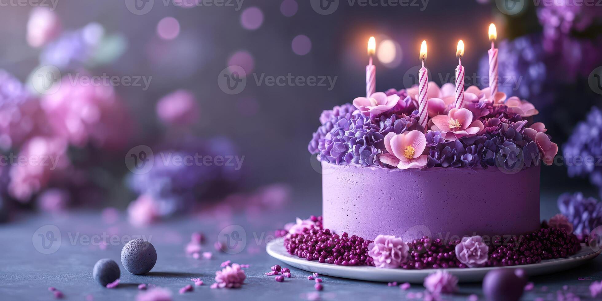 Beautiful purple floral cake with candles celebrating a special occasion photo