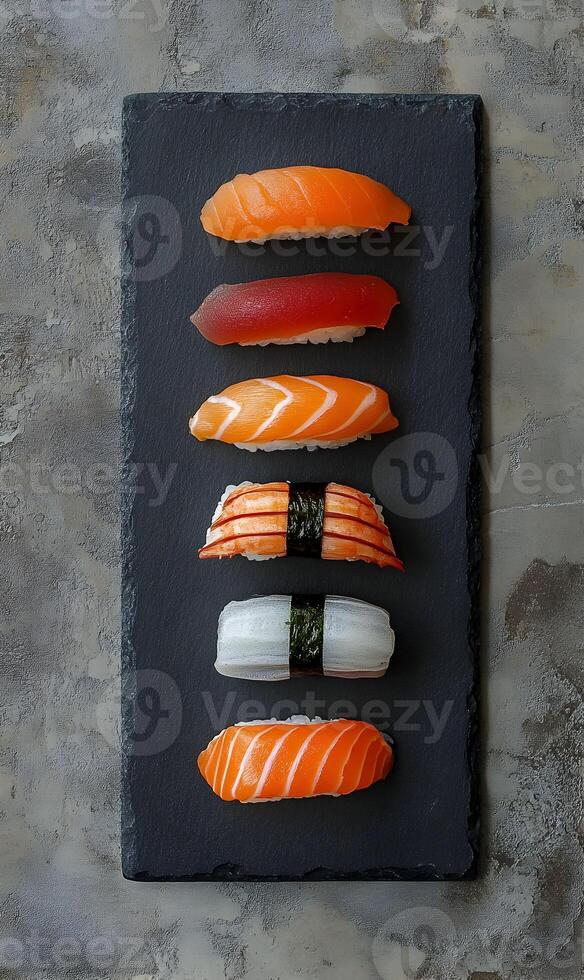 Assortment of nigiri sushi on sleek slate, culinary elegance of japanese seafood cuisine photo