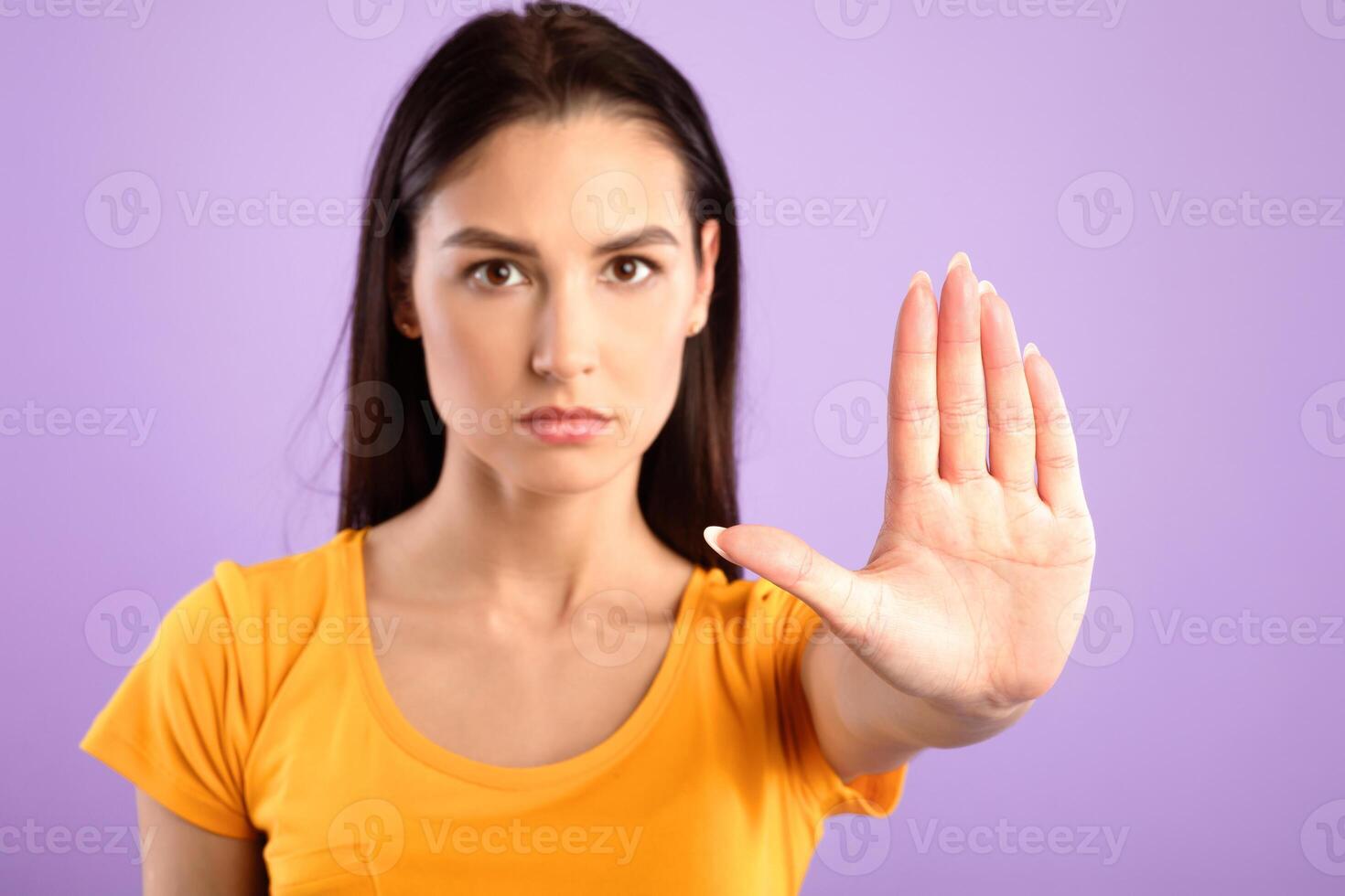 Rejection Concept, Thank You But No. Serious woman making stop hand gesture, blurred background, selective focus photo