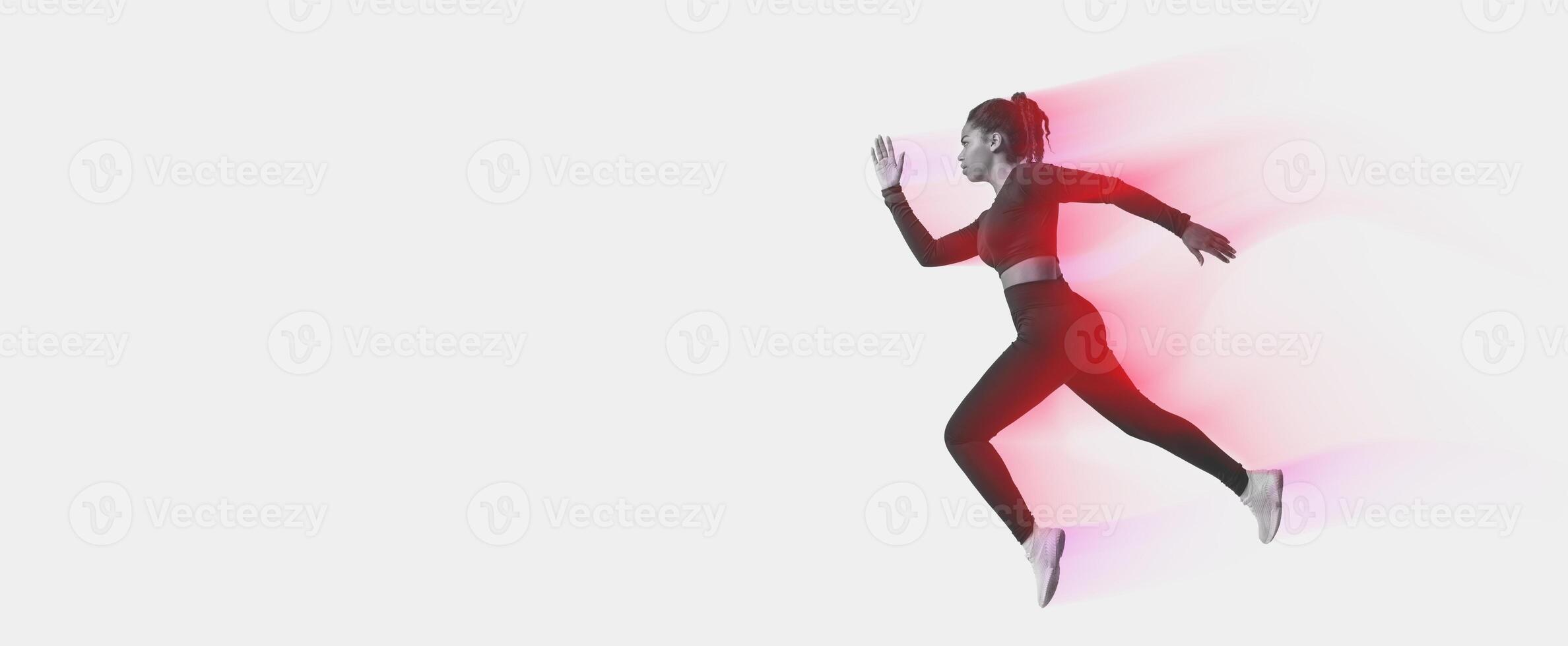 African american woman professional athlete, runner training isolated on neon colored studio background, panorama, copy space, side view. Action, motion, speed, healthy lifestyle photo