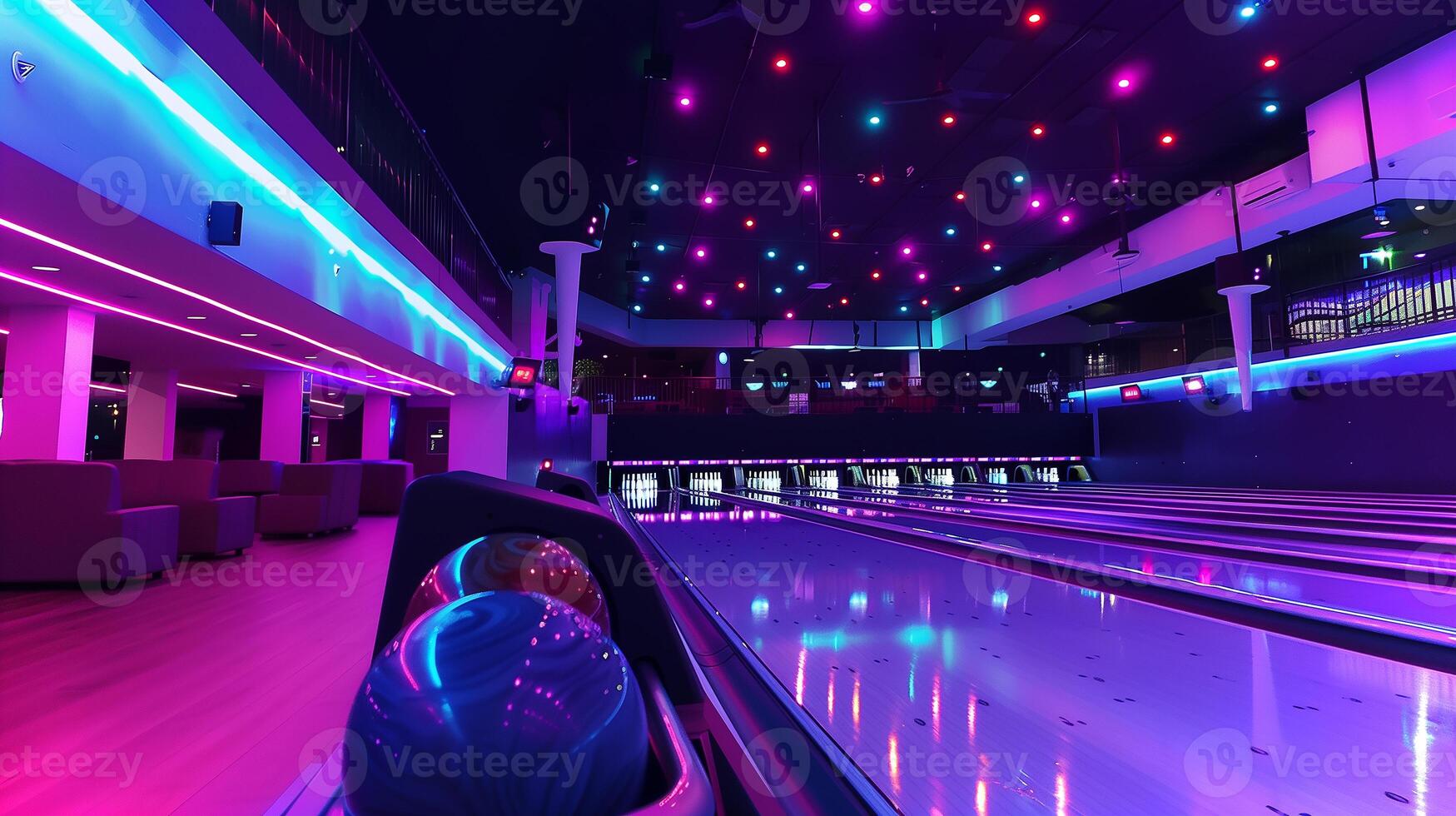 This Bowling lanes illuminated with colorful lights set the mood for a fun night out with friends. photo