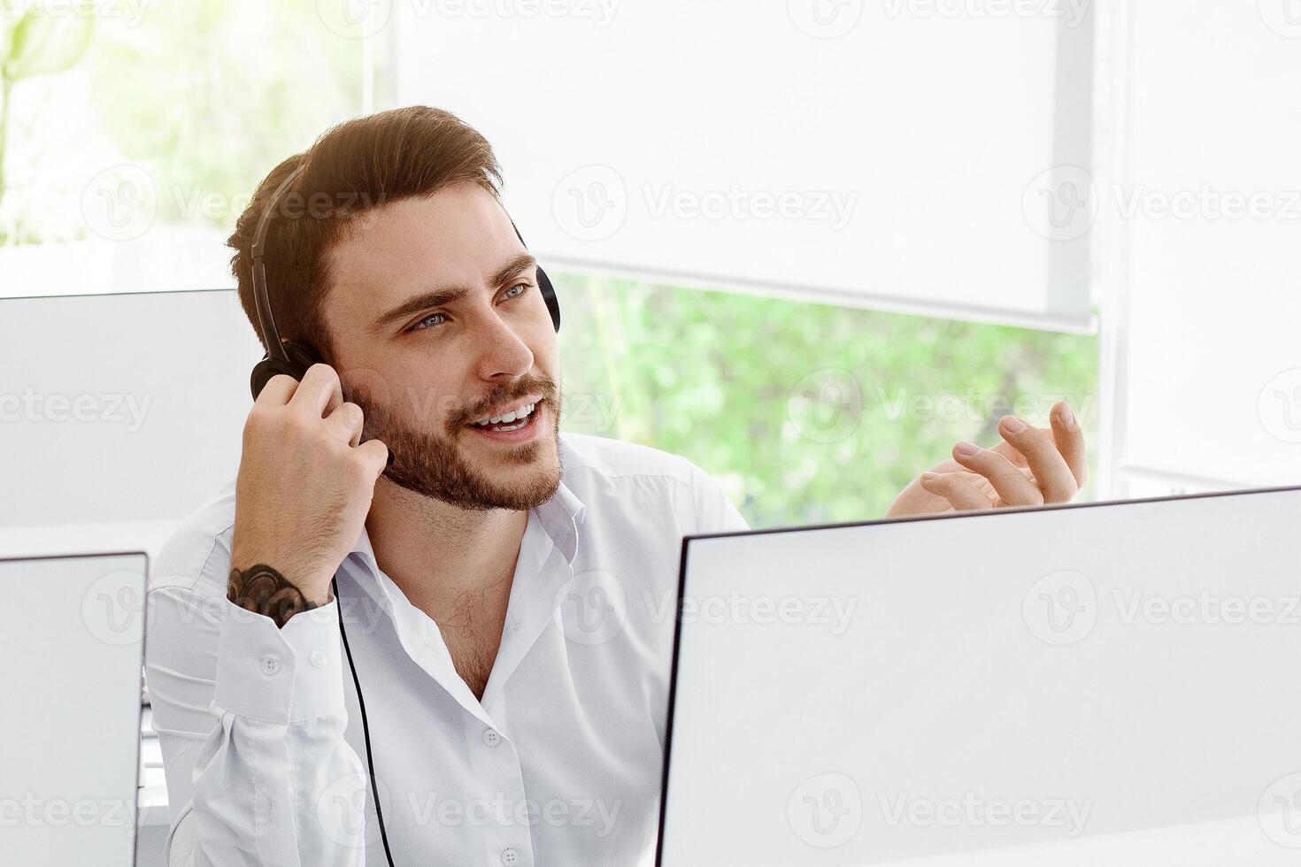 Group of helpline operators at work in modern call centre office photo
