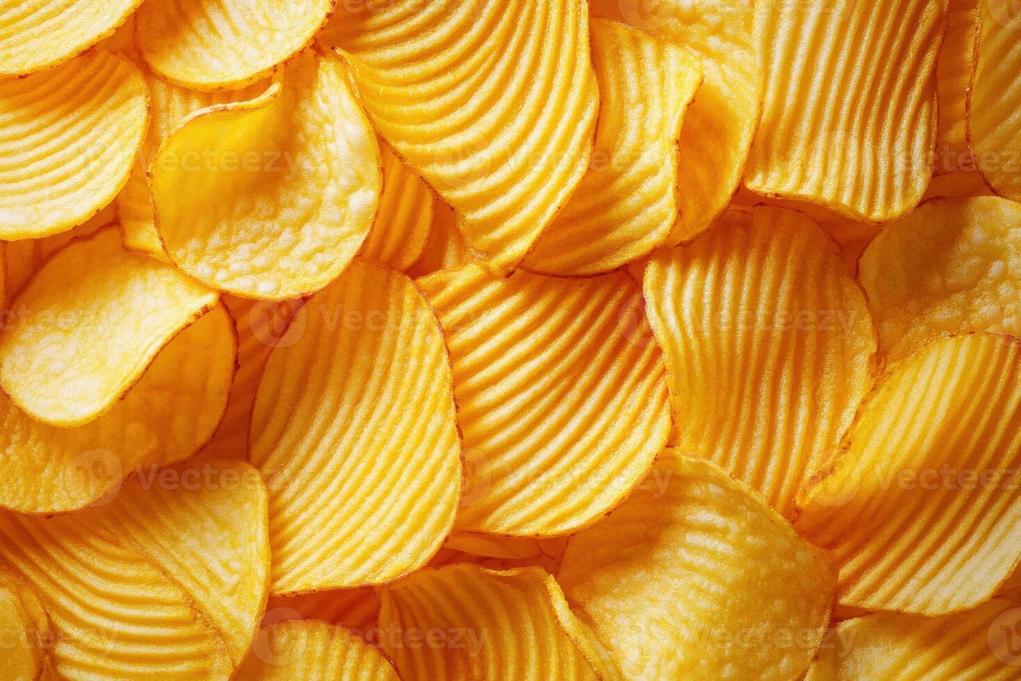 Crunchy golden potato chips arranged neatly on a surface photo