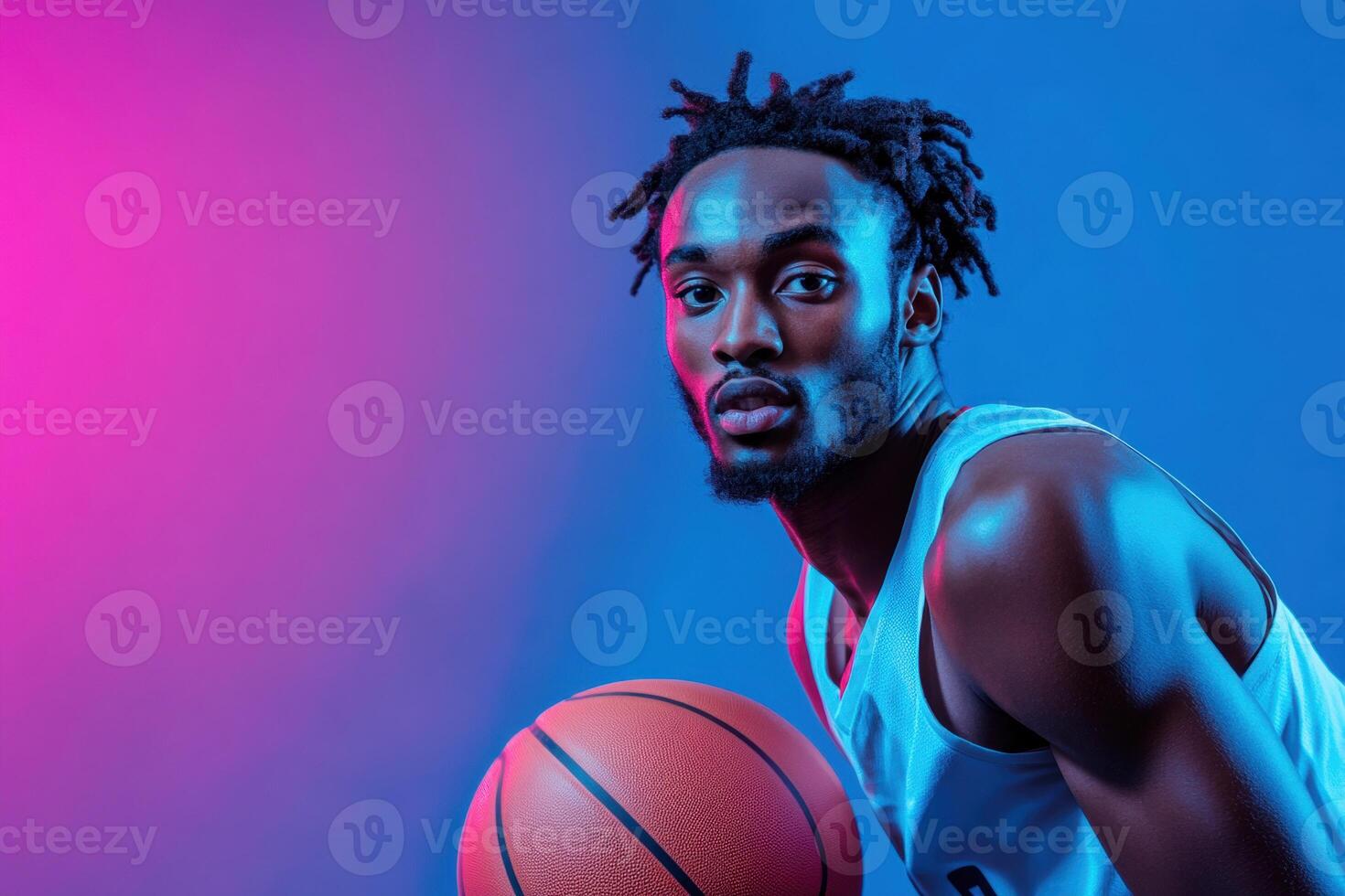 Dynamic basketball player poses with ball under vibrant lights photo