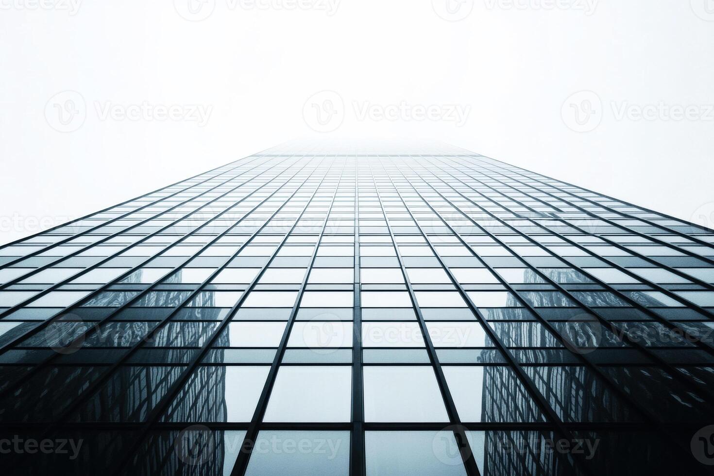 Modern skyscraper reaching into the foggy sky photo