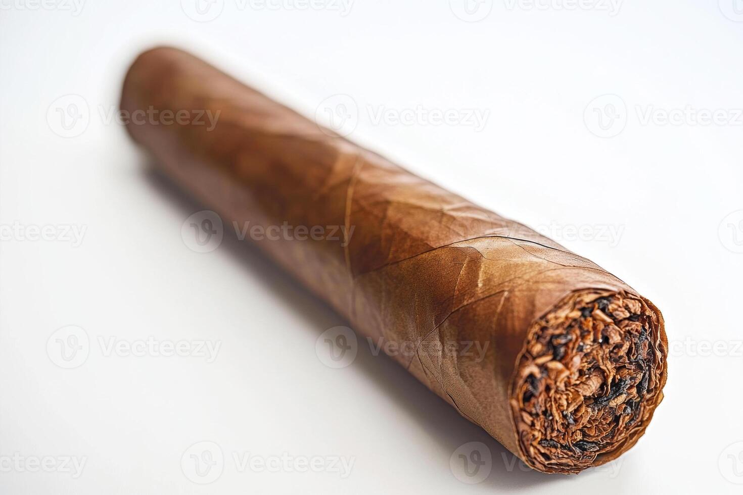 Hand-rolled cigar with natural wrapper displayed on a white surface photo