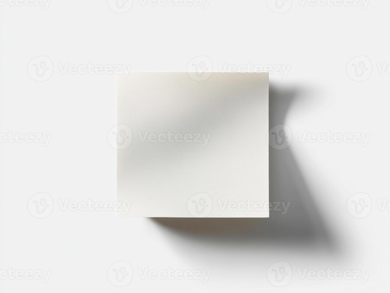 Blank square notepad on a light background casting a soft shadow photo