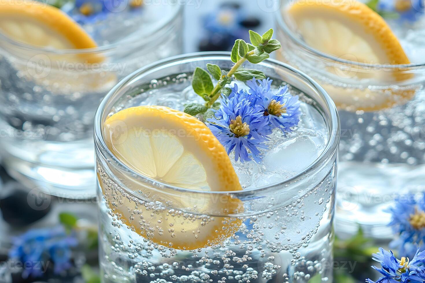 Refreshing Summer Drink with Lemon Slice and Blue Flowers in Sparkling Water Glass photo