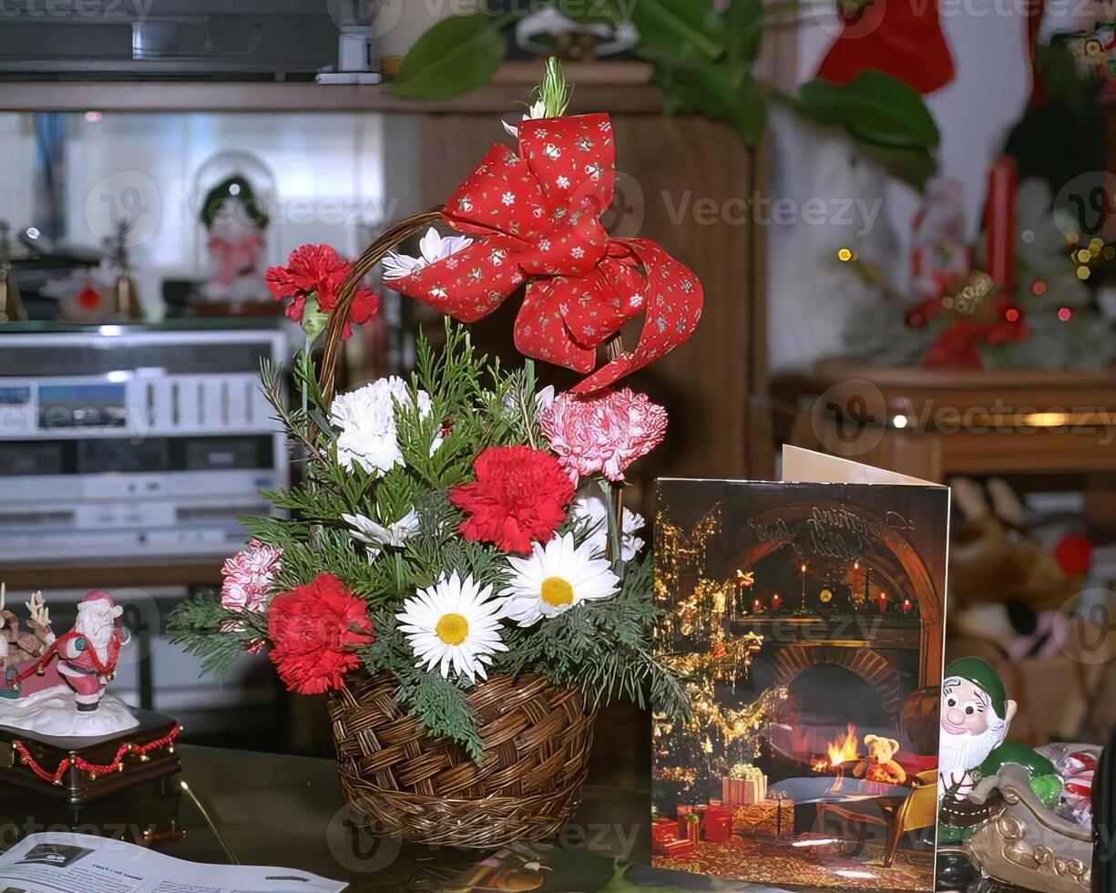 A basket with flowers and a christmas card on a table photo