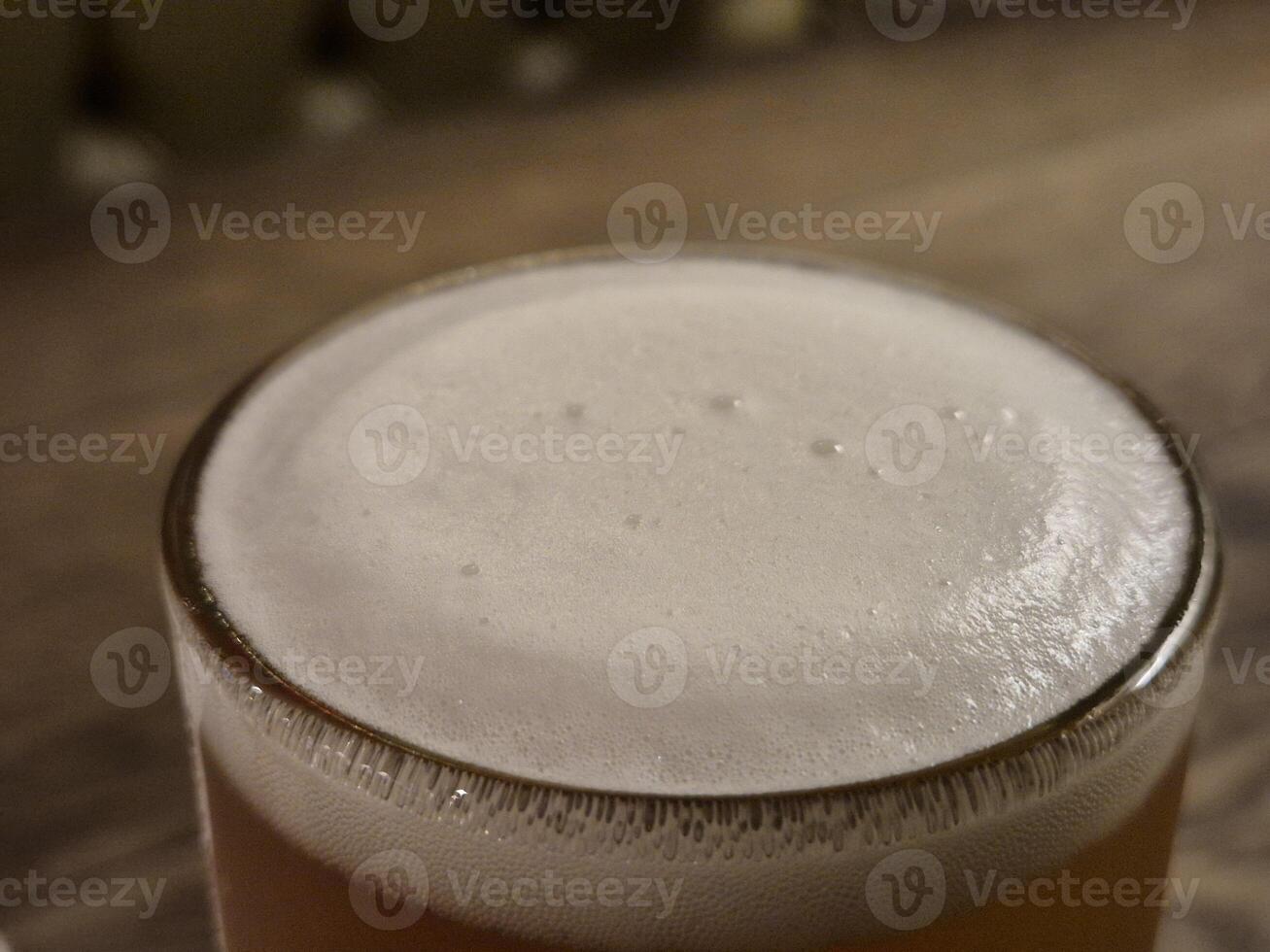 Chilled Beer in Drinkware with Foam on Tableware wallpaper photo