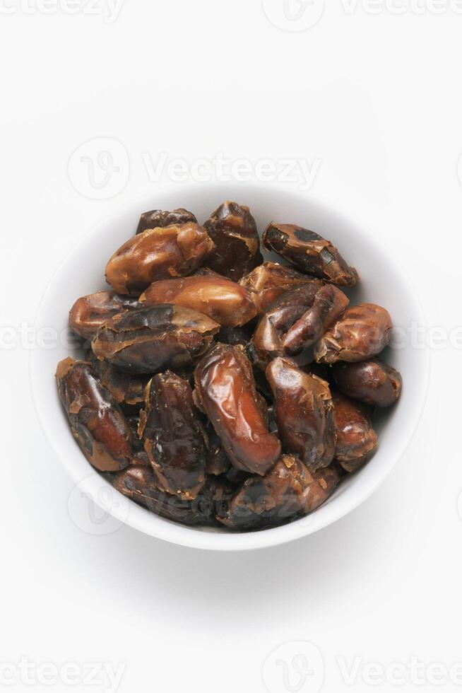 A bowl of dates on a white background photo