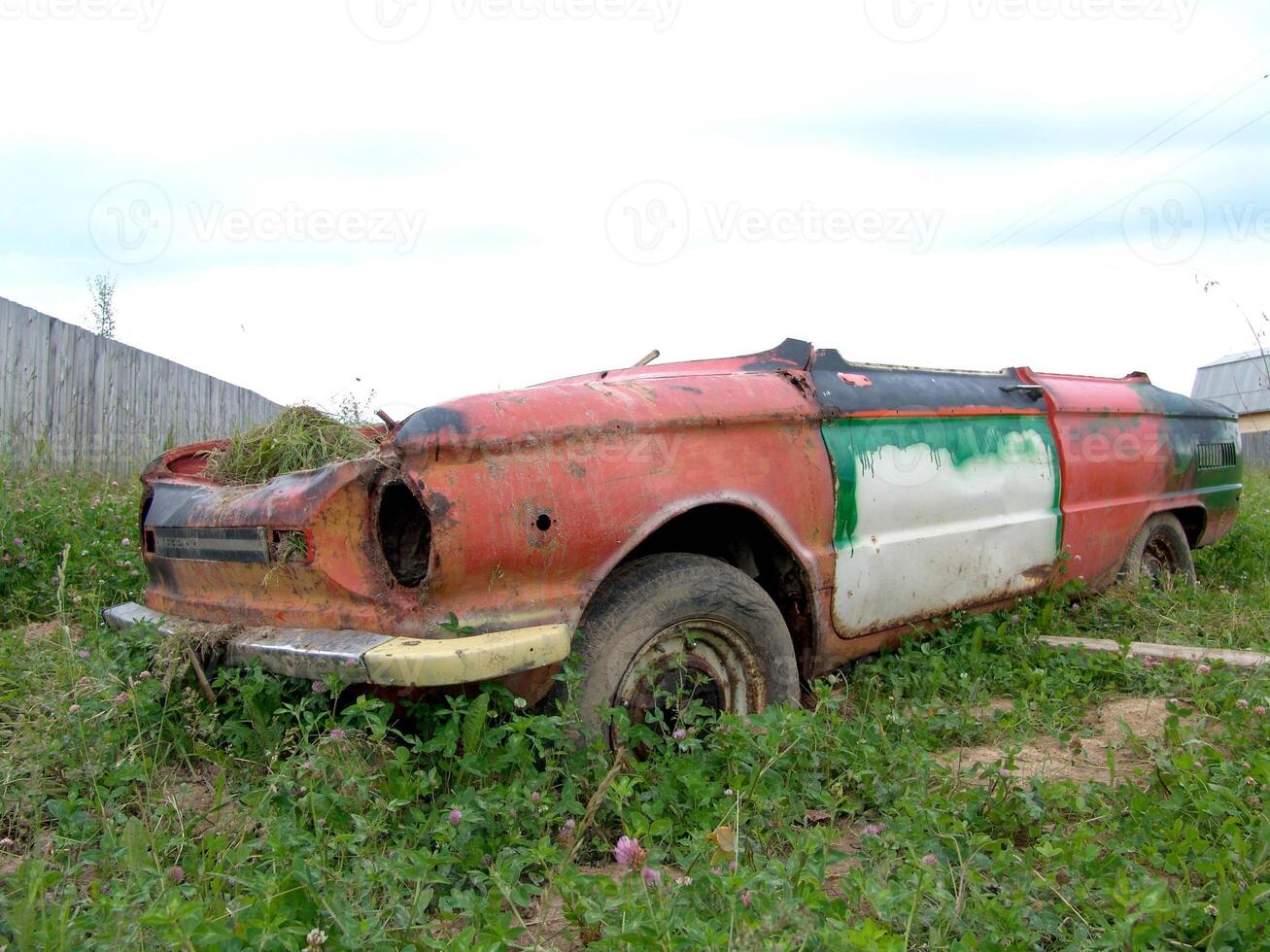 Rusty Abandoned Vintage Convertible Car in Field wallpaper photo