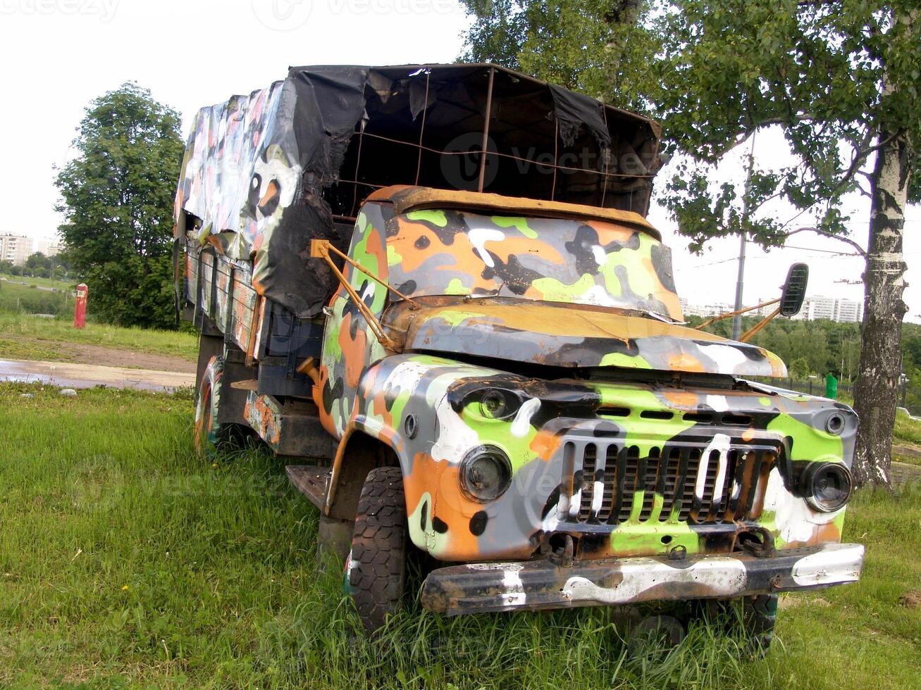 Old Military Truck with Colorful Camouflage Paint creative background photo