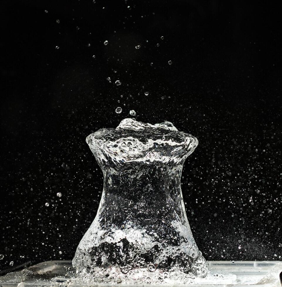 A vase with water splashing out of it photo