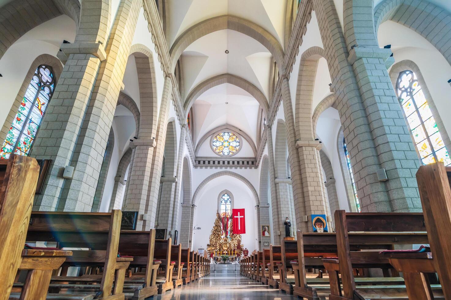 Interior of Christian Catholic church with benches. Sacred Heart of Jesus Cathedral. Tashkent, Uzbekistan - April 18, 2024 photo