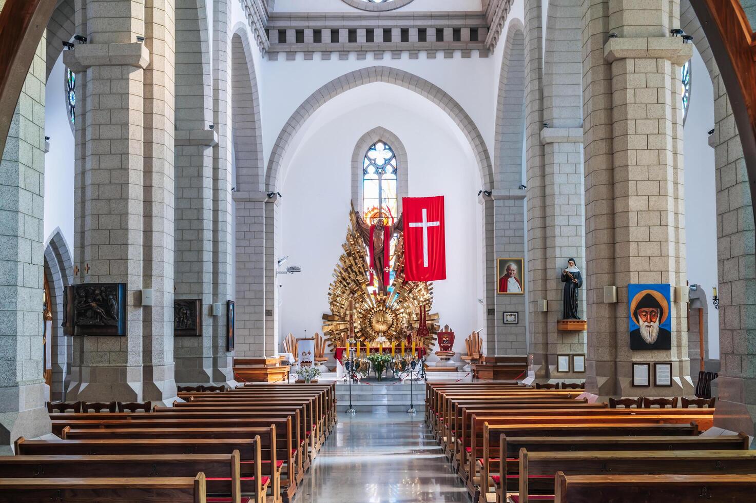 Interior of Christian Roman Catholic church with benches. Sacred Heart of Jesus Cathedral. Tashkent, Uzbekistan - April 18, 2024 photo