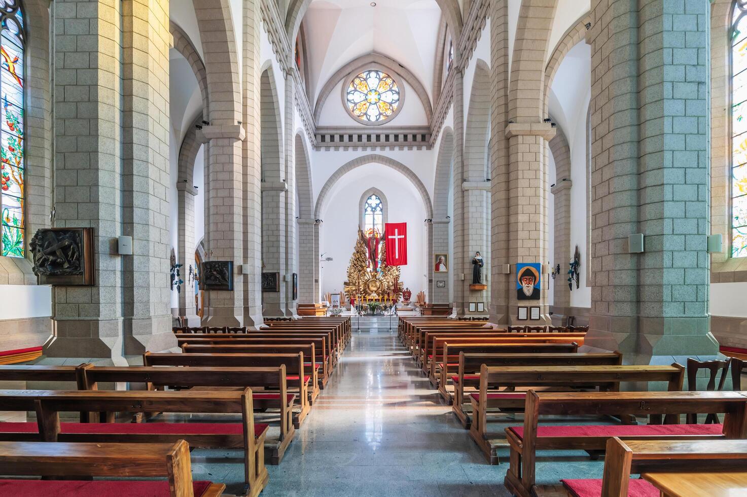 Interior of Christian Roman Catholic church with benches. Sacred Heart of Jesus Cathedral. Tashkent, Uzbekistan - April 18, 2024 photo